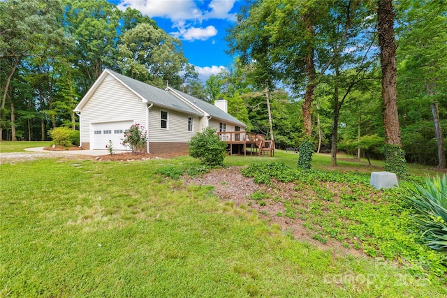 view of property exterior with a lawn, a wooden deck, a chimney, driveway, and a garage