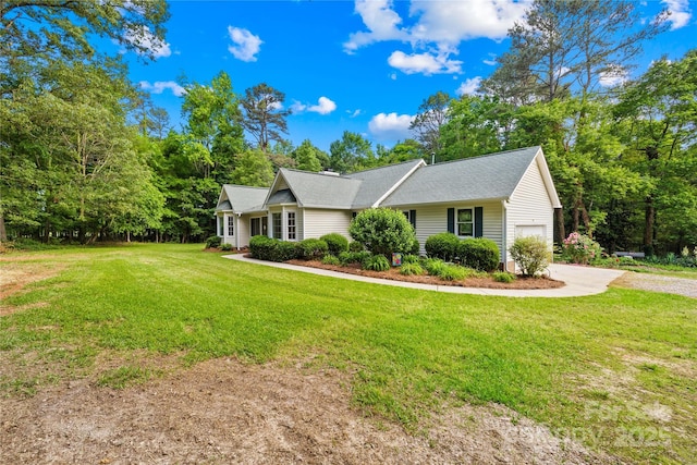 single story home with an attached garage, a front lawn, and driveway