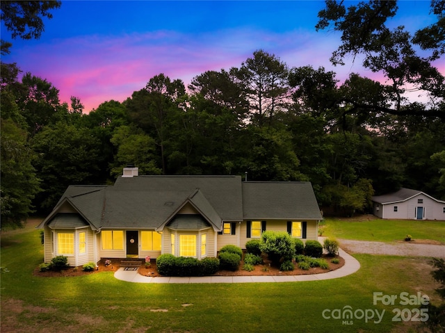 view of front of property featuring a front yard and a chimney