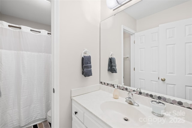 bathroom featuring vanity and toilet