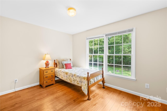 bedroom with baseboards and light wood-type flooring