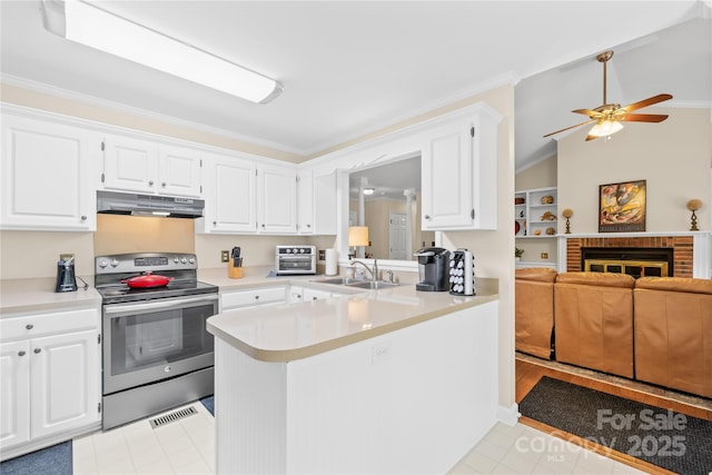 kitchen featuring electric range, under cabinet range hood, a sink, light countertops, and light tile patterned flooring