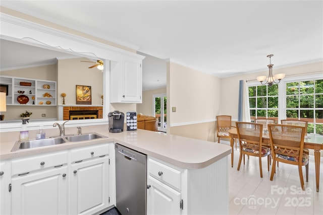 kitchen with dishwasher, a sink, a peninsula, ceiling fan, and light countertops