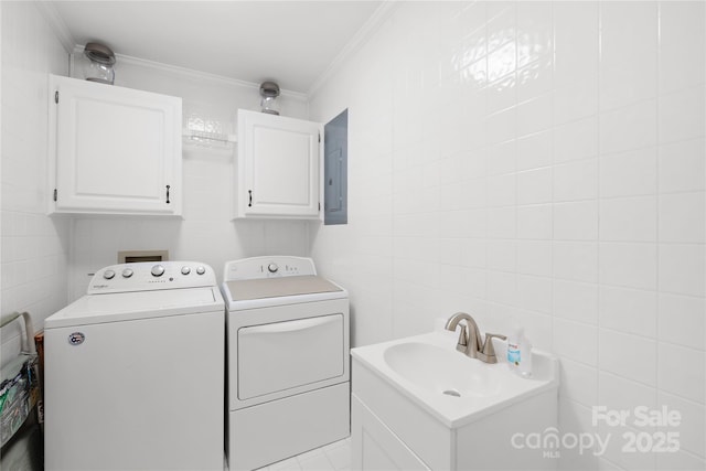 laundry room with independent washer and dryer, tile walls, ornamental molding, and electric panel