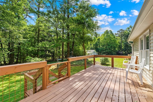 wooden terrace with a lawn