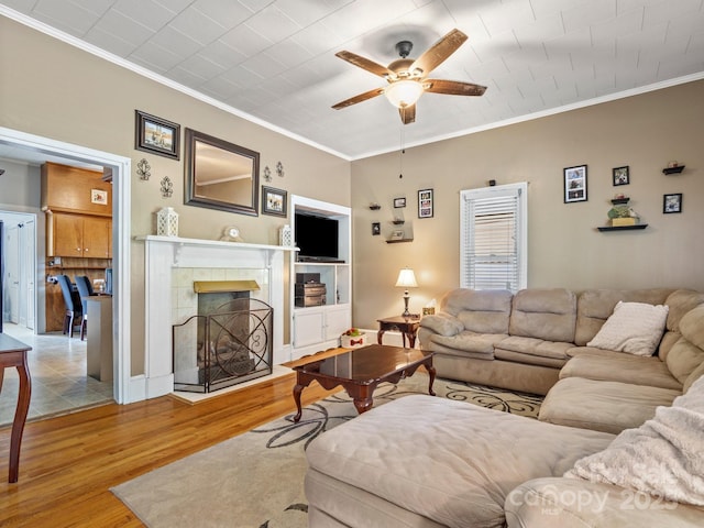170 8th Ave, Cramerton, NC 28032 - living room featuring a ceiling fan, wood finished floors, crown molding, and a tile fireplace