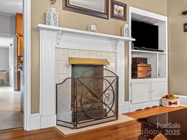 170 8th Ave, Cramerton, NC 28032 - detailed view of wood finished floors, ornamental molding, a tile fireplace, and baseboards