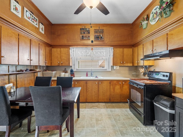 170 8th Ave, Cramerton, NC 28032 - kitchen featuring electric range, under cabinet range hood, a sink, brown cabinetry, and a ceiling fan