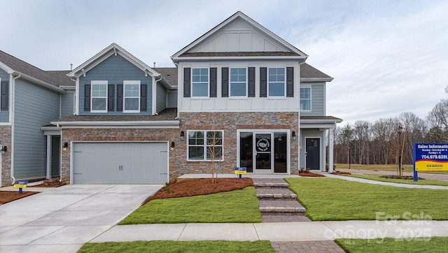 craftsman house featuring a garage, a front yard, stone siding, board and batten siding, and concrete driveway
