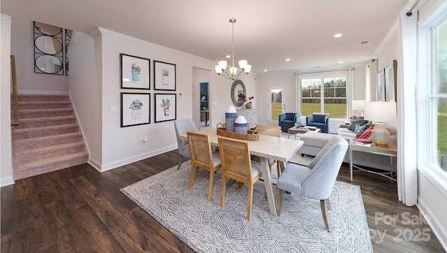 dining room featuring crown molding, a notable chandelier, stairway, and dark wood-style floors
