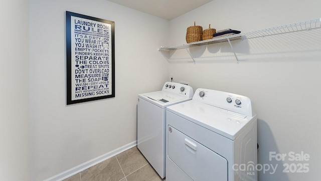 laundry room with independent washer and dryer, light tile patterned flooring, laundry area, and baseboards