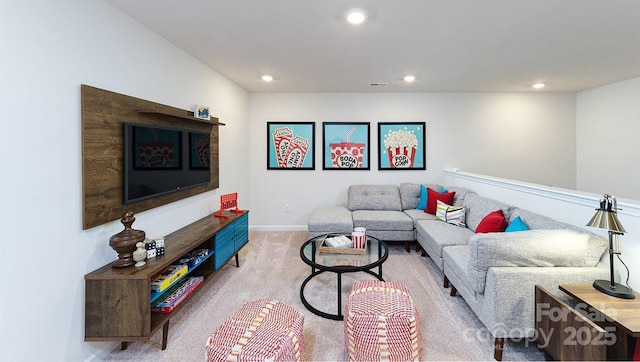 carpeted living room with recessed lighting and baseboards