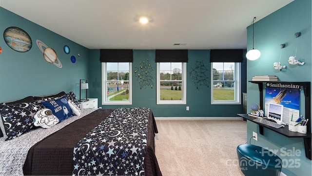 carpeted bedroom featuring baseboards and visible vents