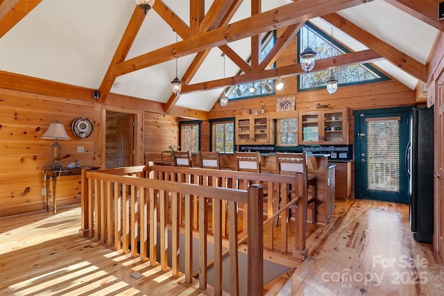 969 Twin Bridges Dr, Fleetwood, NC 28626 - staircase with wood walls, beam ceiling, wood-type flooring, and high vaulted ceiling