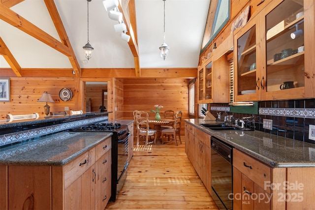 969 Twin Bridges Dr, Fleetwood, NC 28626 - kitchen with a sink, wood walls, black appliances, light wood-style flooring, and decorative backsplash