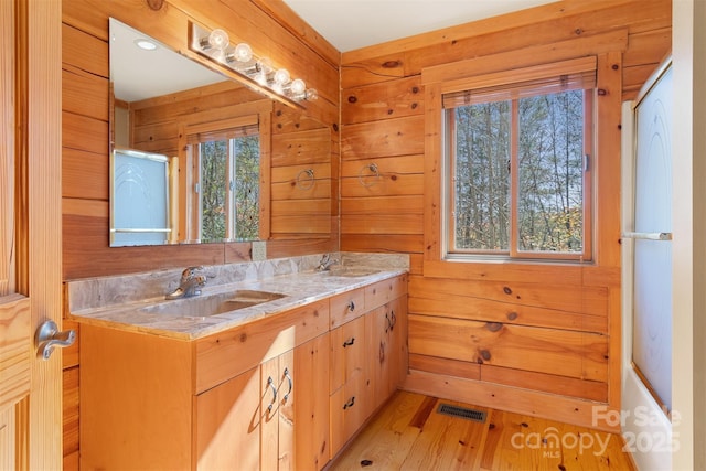 969 Twin Bridges Dr, Fleetwood, NC 28626 - full bath with a sink, double vanity, visible vents, and wood finished floors