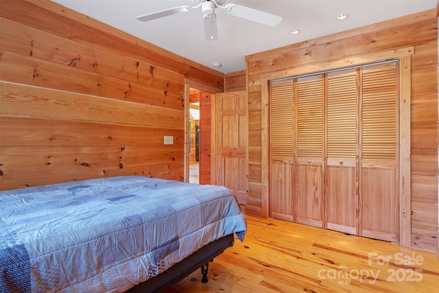 969 Twin Bridges Dr, Fleetwood, NC 28626 - bedroom featuring a closet, recessed lighting, wooden walls, light wood-style flooring, and a ceiling fan