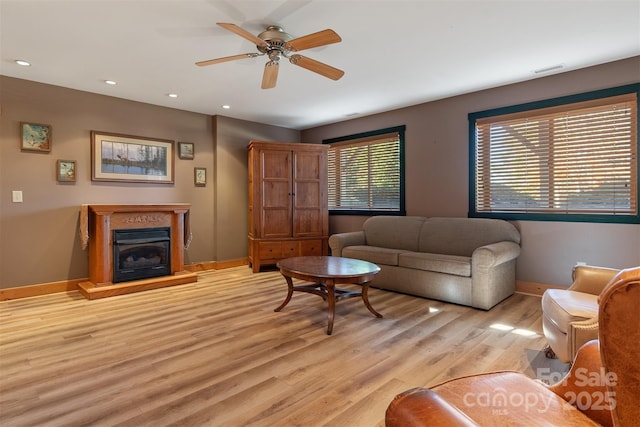 969 Twin Bridges Dr, Fleetwood, NC 28626 - living area with light wood-type flooring, visible vents, baseboards, a glass covered fireplace, and recessed lighting