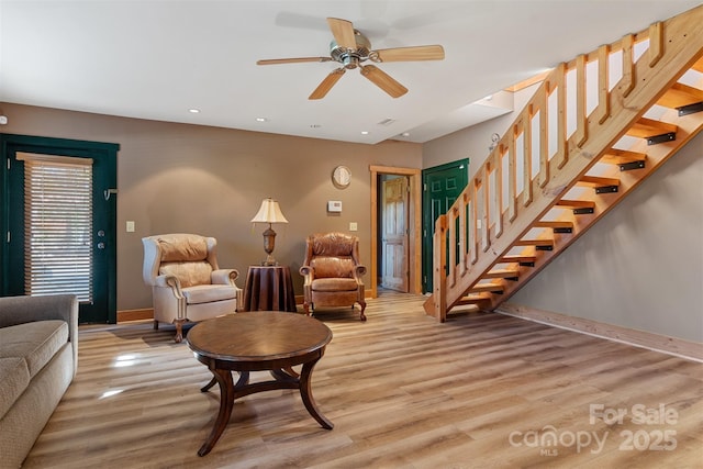 969 Twin Bridges Dr, Fleetwood, NC 28626 - living room with baseboards, stairway, light wood-style flooring, and a ceiling fan