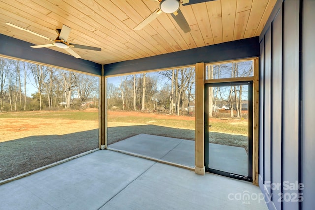 unfurnished sunroom featuring ceiling fan and a healthy amount of sunlight