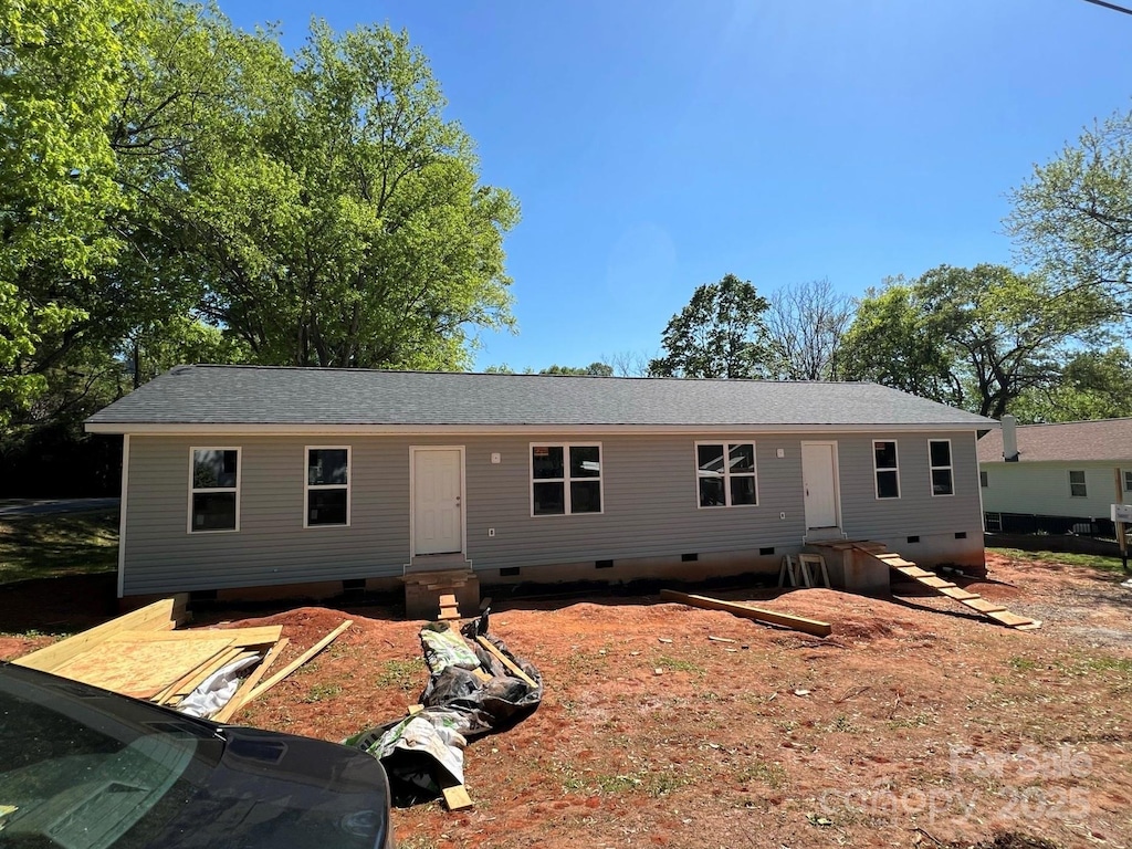 ranch-style house featuring crawl space, entry steps, and roof with shingles