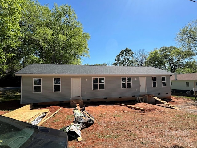 ranch-style house featuring crawl space, entry steps, and roof with shingles