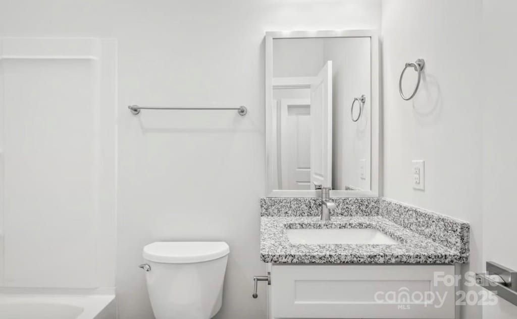 full bath featuring vanity and toilet
