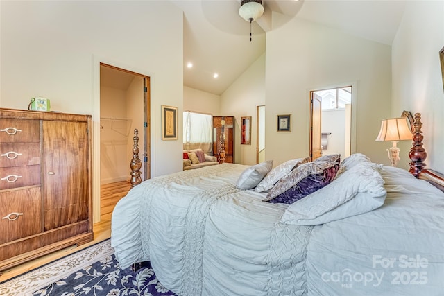 bedroom featuring ensuite bath, high vaulted ceiling, recessed lighting, a ceiling fan, and light wood-style floors