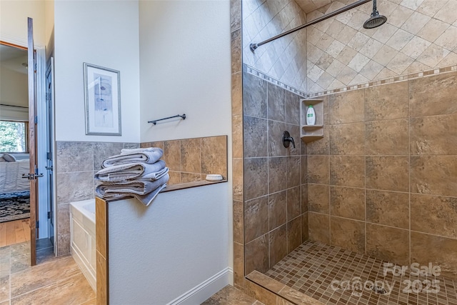 bathroom with a walk in shower and ensuite bath