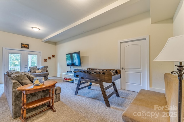 game room featuring light colored carpet, beam ceiling, french doors, and baseboards