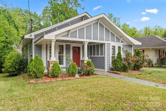 craftsman house with board and batten siding and a front yard