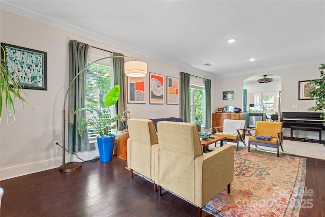 living room with crown molding, wood finished floors, baseboards, recessed lighting, and arched walkways
