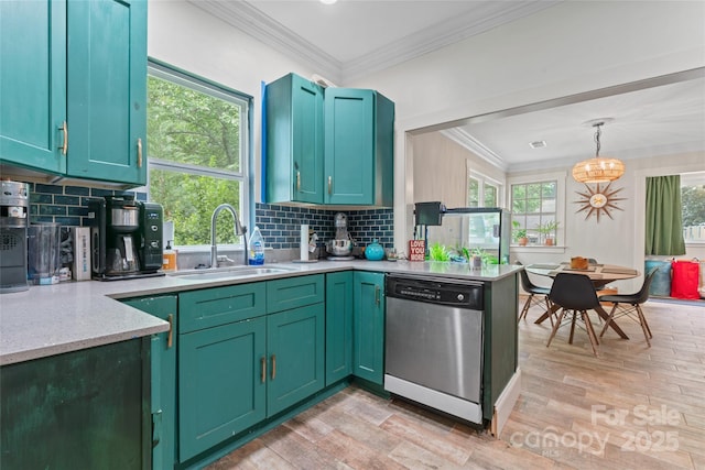 kitchen featuring a sink, ornamental molding, light wood finished floors, and dishwasher