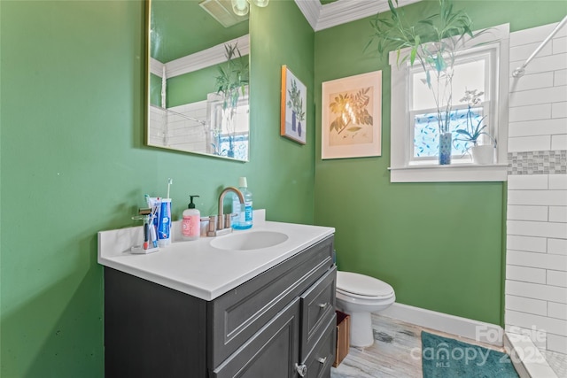 full bath with visible vents, vanity, baseboards, toilet, and ornamental molding