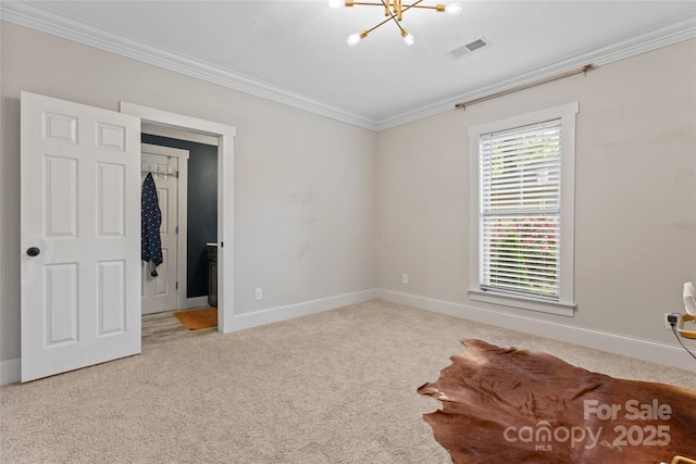 unfurnished bedroom featuring visible vents, baseboards, carpet floors, a chandelier, and ornamental molding