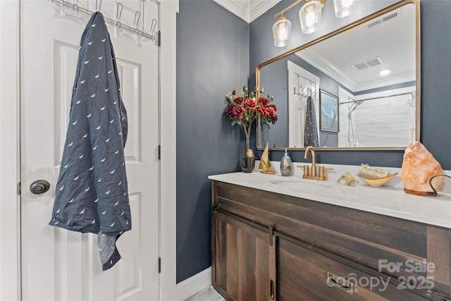 bathroom with crown molding, visible vents, and vanity