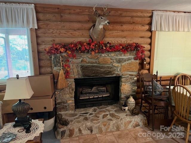 137 Amys Ridge Rd, Lake Lure, NC 28746 - interior space featuring tile patterned flooring, rustic walls, and a stone fireplace