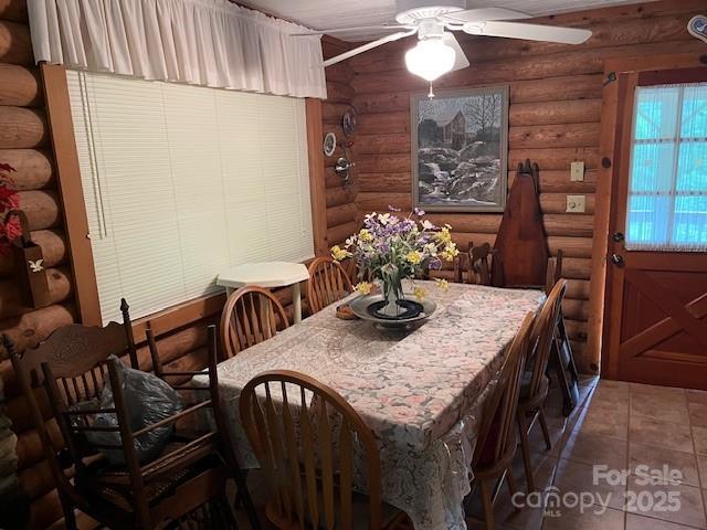 137 Amys Ridge Rd, Lake Lure, NC 28746 - dining space with a ceiling fan, log walls, and tile patterned flooring