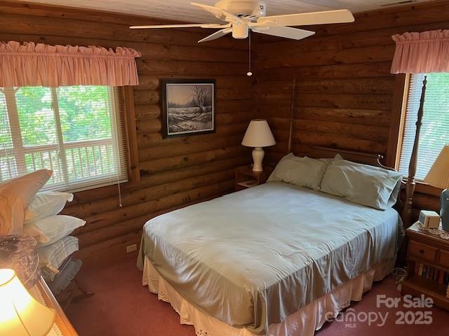 137 Amys Ridge Rd, Lake Lure, NC 28746 - bedroom featuring multiple windows and log walls