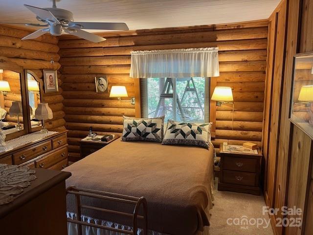 137 Amys Ridge Rd, Lake Lure, NC 28746 - bedroom with rustic walls and light colored carpet