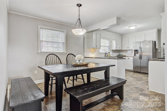 dining room with baseboards and ornamental molding