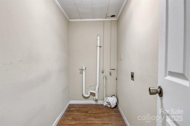 laundry room with laundry area, electric dryer hookup, crown molding, wood finished floors, and baseboards
