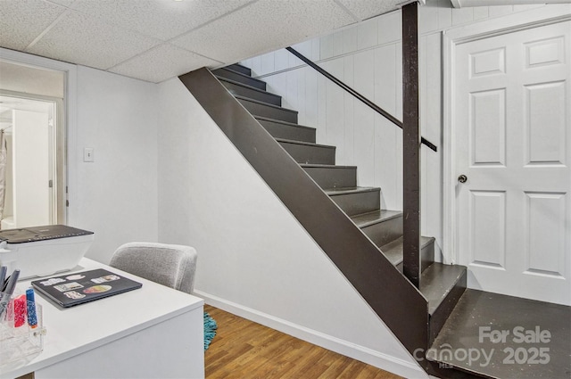 stairway with baseboards and wood finished floors