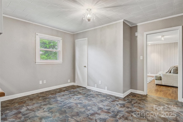 unfurnished bedroom with crown molding, stone finish flooring, and baseboards