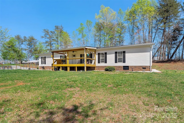 back of property featuring crawl space, ceiling fan, a lawn, and a wooden deck