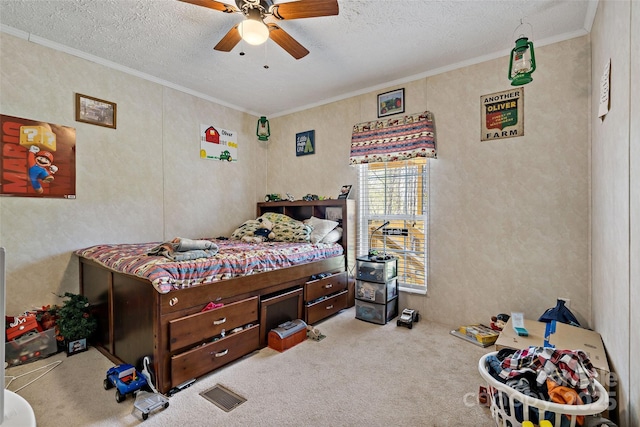 carpeted bedroom with crown molding, a textured ceiling, and ceiling fan