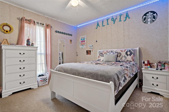 carpeted bedroom featuring a textured ceiling and ceiling fan