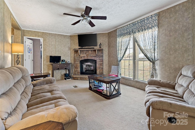 living room with carpet floors, a ceiling fan, a textured ceiling, and a stone fireplace