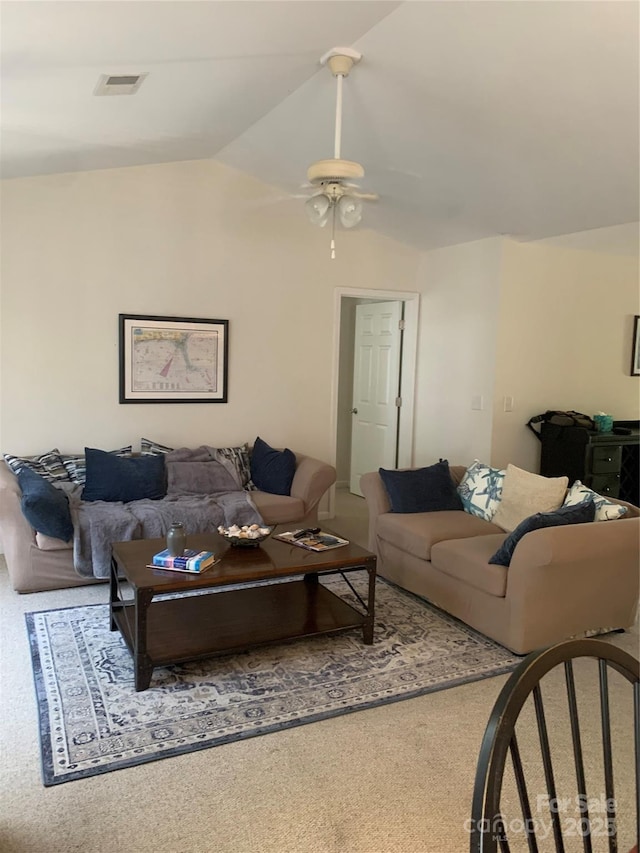carpeted living room with vaulted ceiling, a ceiling fan, and visible vents