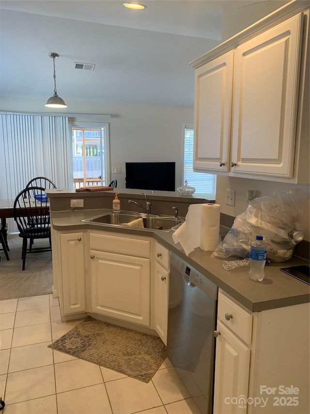 kitchen featuring white cabinets, visible vents, a sink, and dishwasher